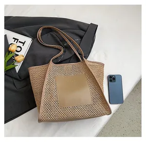 Close-up of woven straw tote bag with brown leather pocket and large capacity for daily use