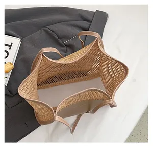 Detail of khaki mesh woven tote bag showing spacious interior and premium mixed materials
