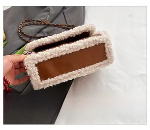 Detail shot of the plush white faux fur trim and brown leather base of the crossbody bag