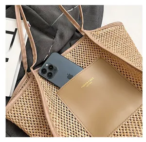 Detail of a straw tote bag featuring a leather front pocket with a smartphone inside