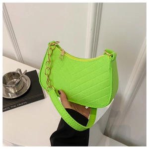 Detail of neon green felt shoulder bag with V-shaped stitching and golden metal chain