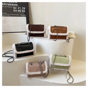 Close-up of five colorful PU leather crossbody bags with faux fur trim on tiered stand