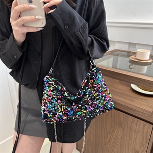 Colorful sequin hobo bag with pearl chain and leather strap in a cafe setting