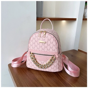 Detail of pink mini backpack with M-pattern print and rhinestone gold chain ornament