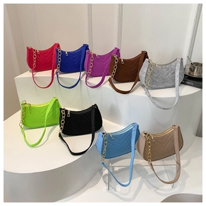 Detailed display of colorful quilted crossbody bags with gold chain straps in various shades