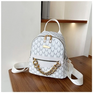 Detailed macro view of white mini backpack with grey monogram and gold chain detail
