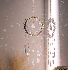 Detail of crystal tree of life dreamcatcher with prisms creating rainbow light reflections