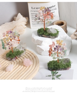 Artistic crystal tree decor with multi-color gemstones on a natural stone base