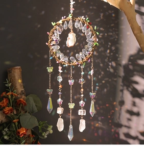 Detail of tree of life suncatcher with white crystal stones and iridescent butterflies