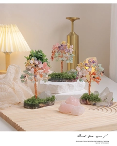 Detailed view of handmade crystal trees with copper wire on a zen wooden tray