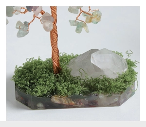 Macro detail of crystal money tree base with resin, faux moss, and raw quartz clusters