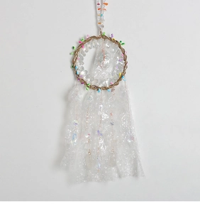 Detailed view of Tree of Life dream catcher with crystals and white tassels for wall decor