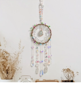 Close-up of bohemian dream catcher with crystal stones and iridescent butterfly charms