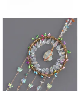 Detailed view of handmade tree of life dreamcatcher with crystals and floral accents