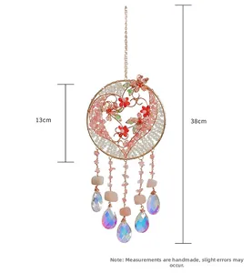 Detailed view of handmade pink crystal Tree of Life wall hanging with glass teardrops