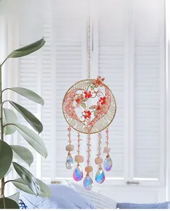 Macro shot of heart-shaped crystal dreamcatcher wall hanging with pink stones