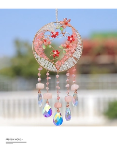 Detail of handmade suncatcher with heart wire, red bead flowers and pink crystals