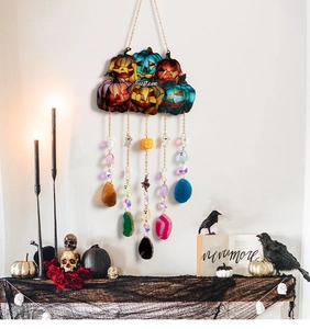 Detail of Halloween pumpkin ornament with agate slices, crystals, and ghost pendants