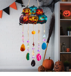 Detailed Halloween wall hanging featuring colorful pumpkin charms and agate slices