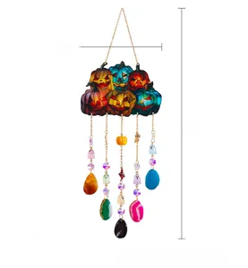 Detail of Halloween pumpkin hanging decor with colorful agate pendants and custom text