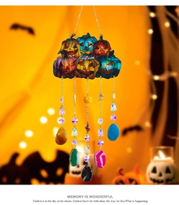 Close-up of Halloween pumpkin wind chime with custom text, crystals, and colorful agate slices