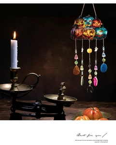 Detail of Halloween pumpkin hanging decor with metallic chains and crystal pendants