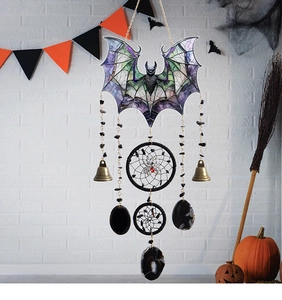 Detail of Halloween black acrylic bat dreamcatcher with spider charms and bells