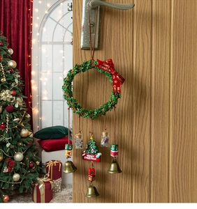 Detail of Christmas wreath with bells and Merry Christmas sign on wood door