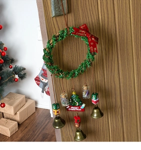 Detailed Christmas wreath wind chime with resin tree tag and rustic metal bells on door