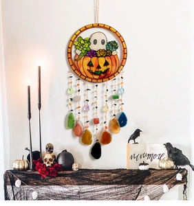 Detail of Halloween wooden wall hanging with pumpkin ghost art and agate bead tassels