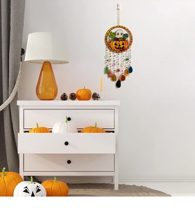 Detail of Halloween wall hanging with pumpkin patterns and natural raw stone slices