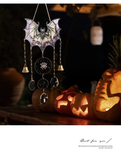 Halloween black acrylic bat pendant with bell and stones on pumpkin background