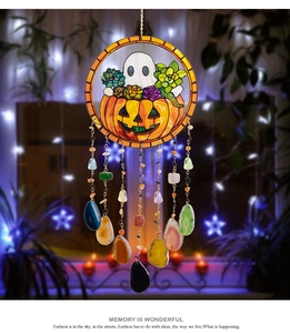 Detail of Halloween wind chime featuring pumpkin motifs and natural agate stone charms