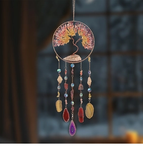 Detail of Tree of Life suncatcher with raw crystal stones and colorful agate slices