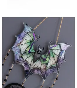 Macro shot of gothic acrylic bat pendant with stained glass effect and golden chain
