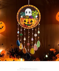 Detail of Halloween wreath with agate slices, pumpkin stained glass, and metal chains
