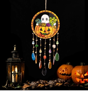 Macro detail of Halloween pumpkin ghost ornament with agate stones and maple leaves