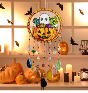 Detail view of a Halloween wind chime with stained glass pumpkin, ghost, and agate slices