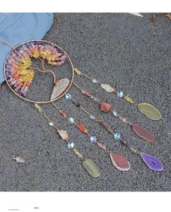 Detailed close-up of tree of life suncatcher with natural crystals and agate slices