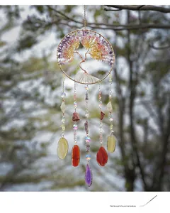 Detail of tree of life wind chime with colorful crystals and hanging agate slices