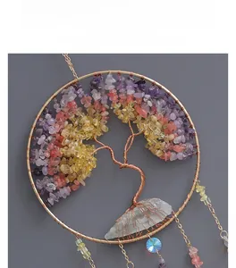 Detail of handmade Tree of Life wall hanging with colorful crystal chips and large raw quartz