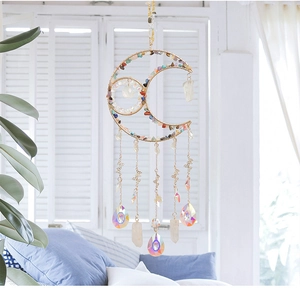Detail of moon suncatcher with colorful crystals, golden butterfly and aurora prisms