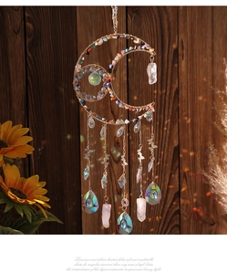 Detailed view of handmade moon suncatcher with colorful crushed crystals and butterfly charms