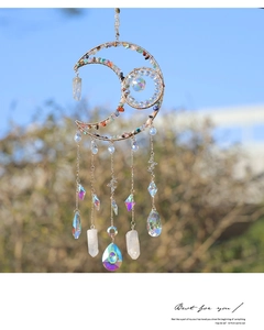 Detail of moon-shaped suncatcher with colorful crystals and aurora hanging prisms