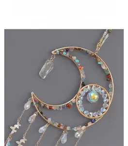 Detail of crescent moon suncatcher with colorful crushed stones and crystal prisms