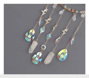 Detail of suncatcher featuring colorful crystal chips, gold chain, and a butterfly charm