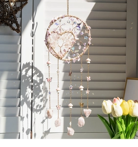 Detail of pink crystal Tree of Life dreamcatcher with hanging raw gemstones and beads