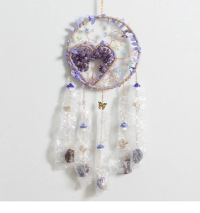 Detail view of tree of life dreamcatcher with purple crystal stones and metal pendants