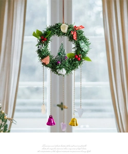 Close-up of Christmas wreath with natural crystals, red berries and gold bells hanging