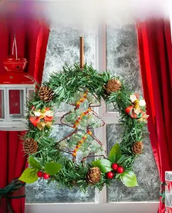 Detailed Christmas wreath with pine cones, berries and a crystal stone tree pendant